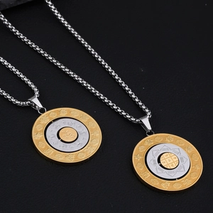 Detail of rotating titanium steel pendant with zodiac and religious Buddhist engraving