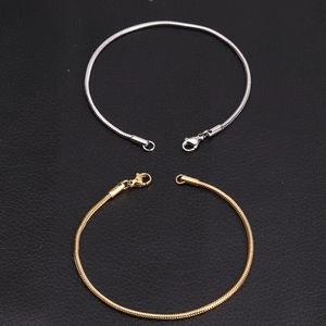 Detailed view of silver and gold stainless steel snake chains with lobster clasps