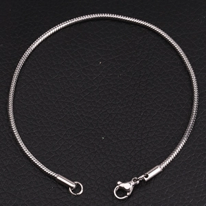 Detailed macro view of the silver stainless steel snake chain with lobster clasp closure