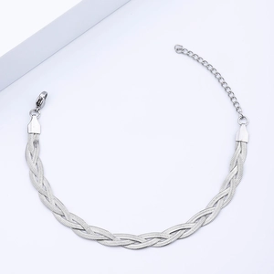 Detail of woven stainless steel snake bone bracelet with lobster clasp and extension chain