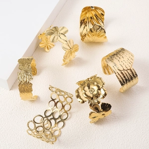 Detailed collection of 18K gold plated cuff bracelets featuring floral and textured designs