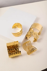 Set of four 18K gold plated cuff bracelets featuring feather, butterfly, and hammered textures