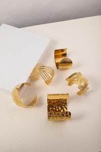 Detail of 5-piece 18K gold plated stainless steel bangles featuring textured and hollow designs