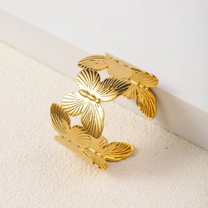 Detail of 18K gold plated stainless steel butterfly cuff with intricate wing texture