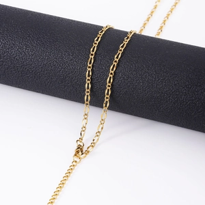 Close-up of 18k gold plated stainless steel Figaro chain necklace with lobster clasp