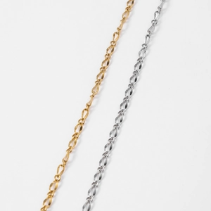 Detailed macro view of 18k gold and silver stainless steel twisted lip chain necklaces
