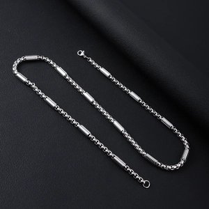 Detail of silver stainless steel chain with cylindrical accents and lobster clasp