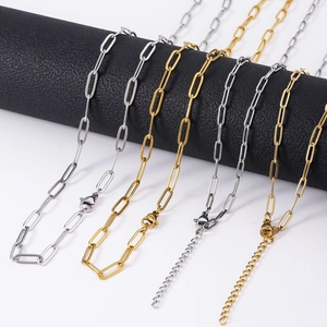 Close-up of gold and silver stainless steel paperclip chains with lobster clasp details