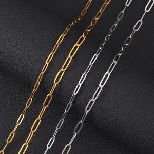 Close-up of gold and silver stainless steel paperclip chain links on black leather