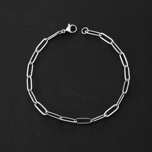 Close-up of a silver stainless steel paperclip chain bracelet with a classic lobster clasp