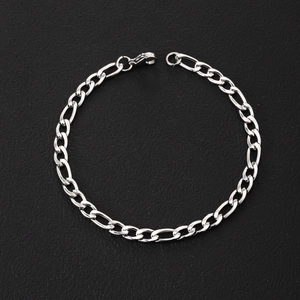Detailed macro view of classic silver stainless steel Figaro chain with lobster clasp