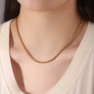 Minimalist 18K gold plated stainless steel bead chain necklace worn by a female model