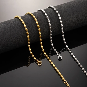 Detail of 18K gold and silver bead chain necklaces with lobster clasp on a black display