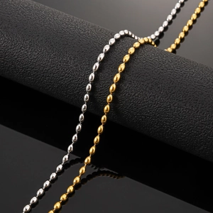 Detail of silver and 18K gold plated stainless steel bead chain necklaces on black display