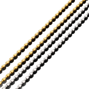 Polished gold and silver stainless steel oval bead chains on a reflective background