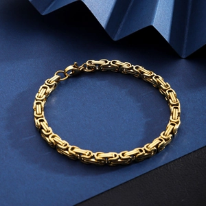 Detail of gold 18K plated stainless steel Byzantine chain with lobster clasp and woven texture