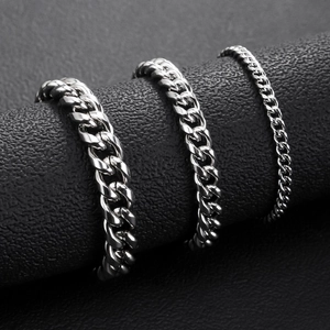 Detailed close-up of polished stainless steel Cuban chains in three different widths