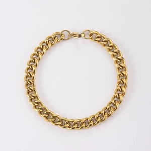 Close-up of golden stainless steel Cuban link bracelet with high-shine polished finish