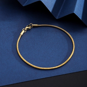 Close-up of golden stainless steel snake chain bracelet with a secure lobster clasp