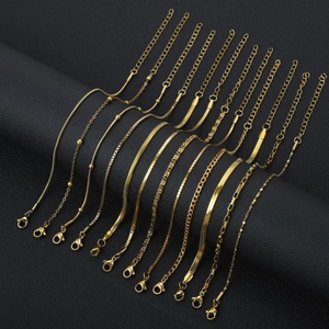 Detailed macro view of assorted 18K gold plated stainless steel chain styles on black leather