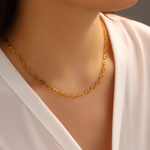 Elegant 18K gold plated stainless steel hollow heart link necklace worn by a model