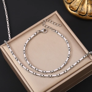 Polished silver stainless steel box chain necklace with lobster clasp on display stand