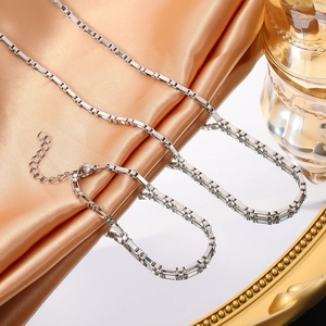 Minimalist silver stainless steel box chain necklace with lobster clasp on silk fabric