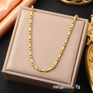 Detail of 11.7g golden stainless steel box chain necklace on luxury jewelry display