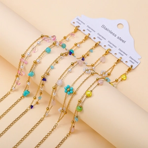 Detail of 18K gold plated stainless steel bracelets with natural stones and pearls