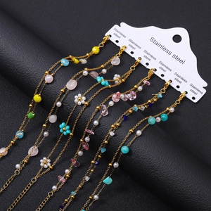 Detail of 18K gold plated stainless steel bracelets with colorful natural stone beads