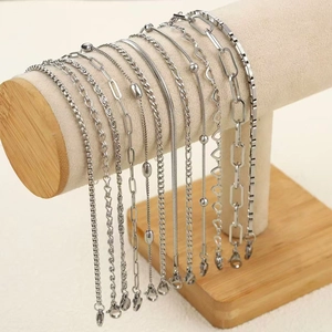 Detailed set of silver stainless steel chain bracelets featuring lobster clasps on display