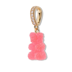 Macro detail of a pink gummy bear pendant with sugar texture and gold zircon clasp