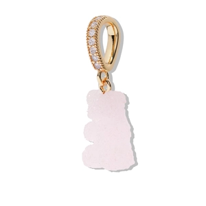 Macro detail of a pink bear pendant with a sugar texture and gold zircon-set clasp