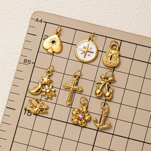 Golden stainless steel charms set including sun, moon and anchor pendants in 18K gold plating