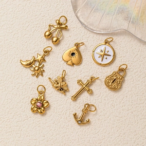Set of 9 gold-plated stainless steel pendants with cherry, star and anchor designs