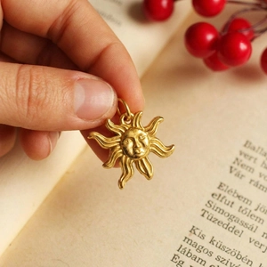 Retro golden sun face pendant charm with matte finish and wavy rays for DIY jewelry