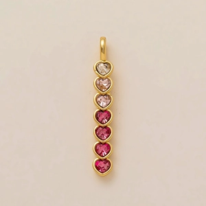 Vertical gold pendant with seven heart-shaped stones in pink and purple gradient
