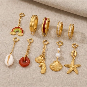 Golden stainless steel jewelry charm set featuring shells, starfish, and 18K plated ear hoops