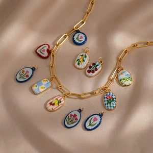 Gold plated rectangle chain necklace with floral ceramic and enamel heart charms