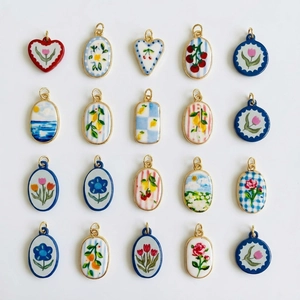 Assortment of ceramic floral pendants with gold edges featuring vintage garden motifs