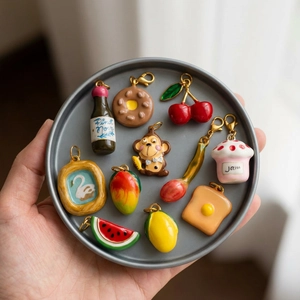 Colorful handmade enamel fruit and food charms in a 18K gold plated metal tray