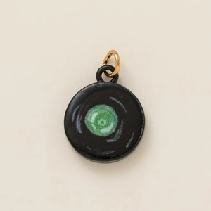 Artistic round ceramic pendant with black finish and sparkling green center detail