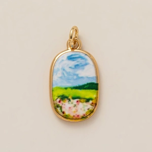 Oval gold plated ceramic pendant featuring a hand-painted landscape and nature scene