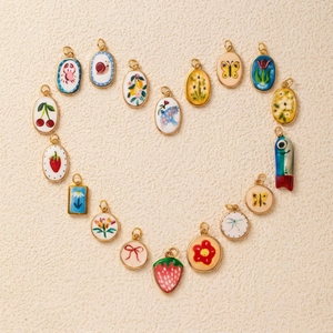 Colorful enamel charms heart-shaped collage with floral and animal gold-plated pendants