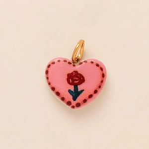 Pink heart-shaped pendant with red rose pattern and golden metal loop accessory