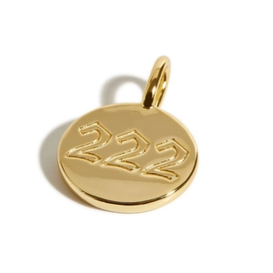Macro view of 18K gold plated 222 angel number charm with polished metallic finish
