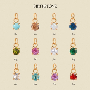 Macro view of 12 colors of round-cut birthstone pendants with 18k gold claw settings