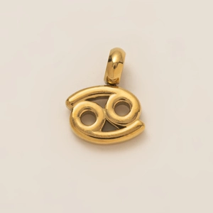 Detailed view of polished gold Cancer zodiac pendant with smooth metallic finish