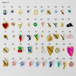 Detailed selection of enamel gold pendants including cowboy boots, hearts and evil eyes