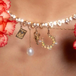 18K gold plated stainless steel necklace with passport, lobster, and horseshoe pendants